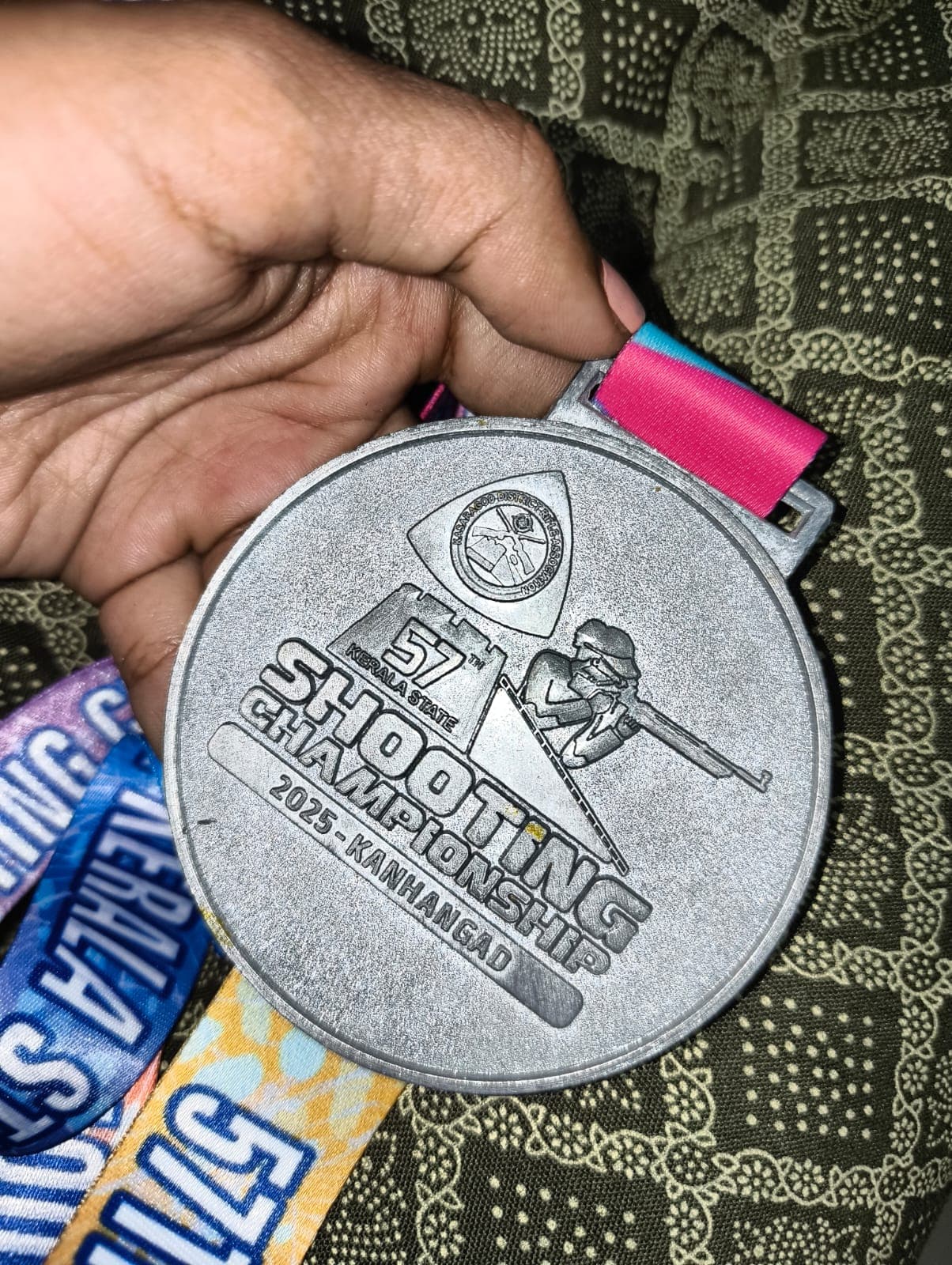 Close-up of a silver medal from the 57th Kerala State Shooting Championship 2025, Kanhangad